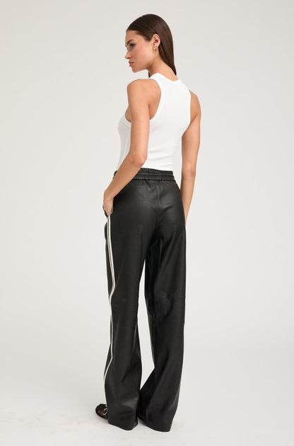 person wearing sprwmn womens Leather Baggy Athletic Stripe Sweatpants in Black