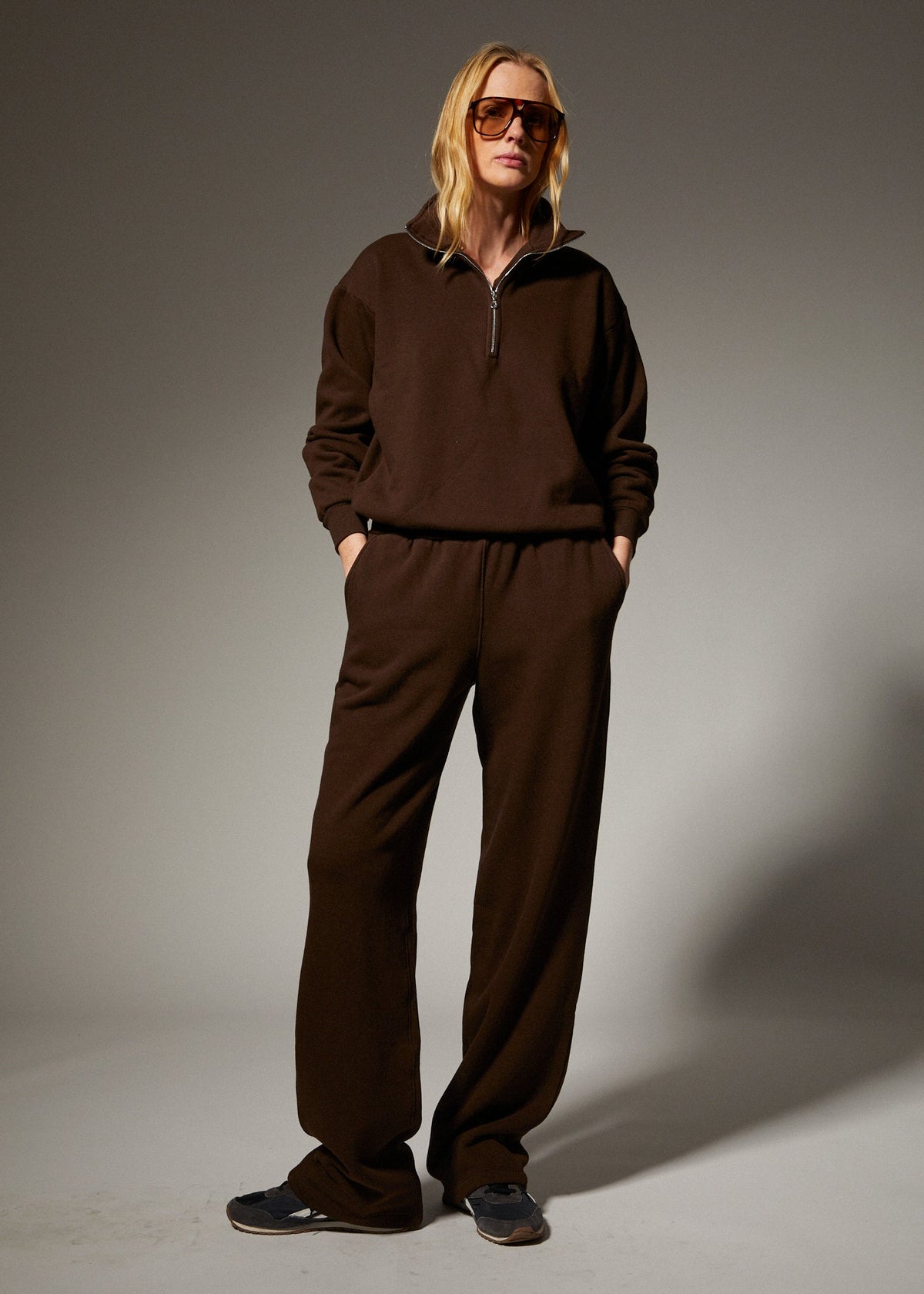 person wearing sprwmn womens Straight Leg Sweatpants quarter zip sweatshirt in Americano