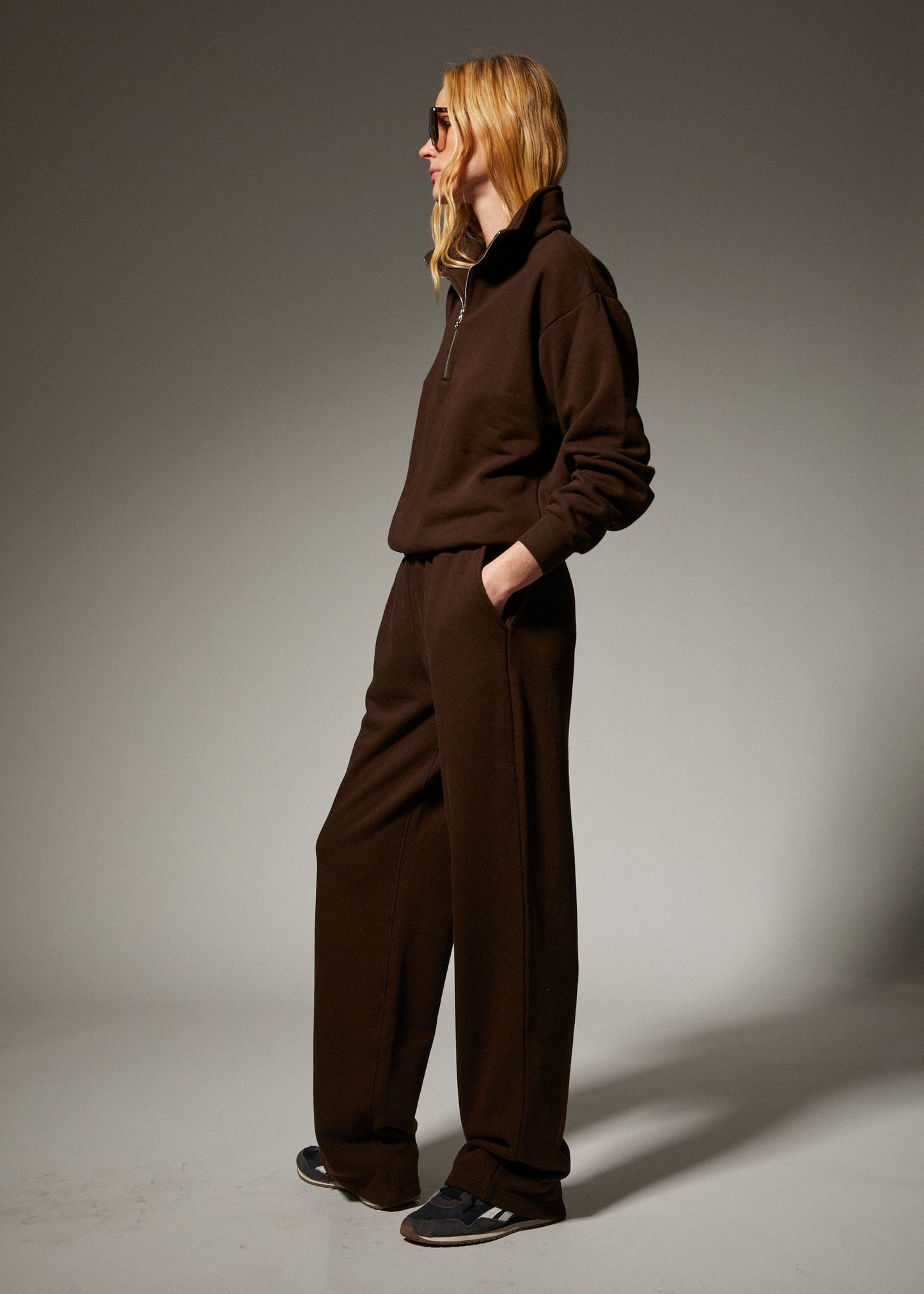 person wearing sprwmn womens Straight Leg Sweatpants quarter zip sweatshirt in Americano