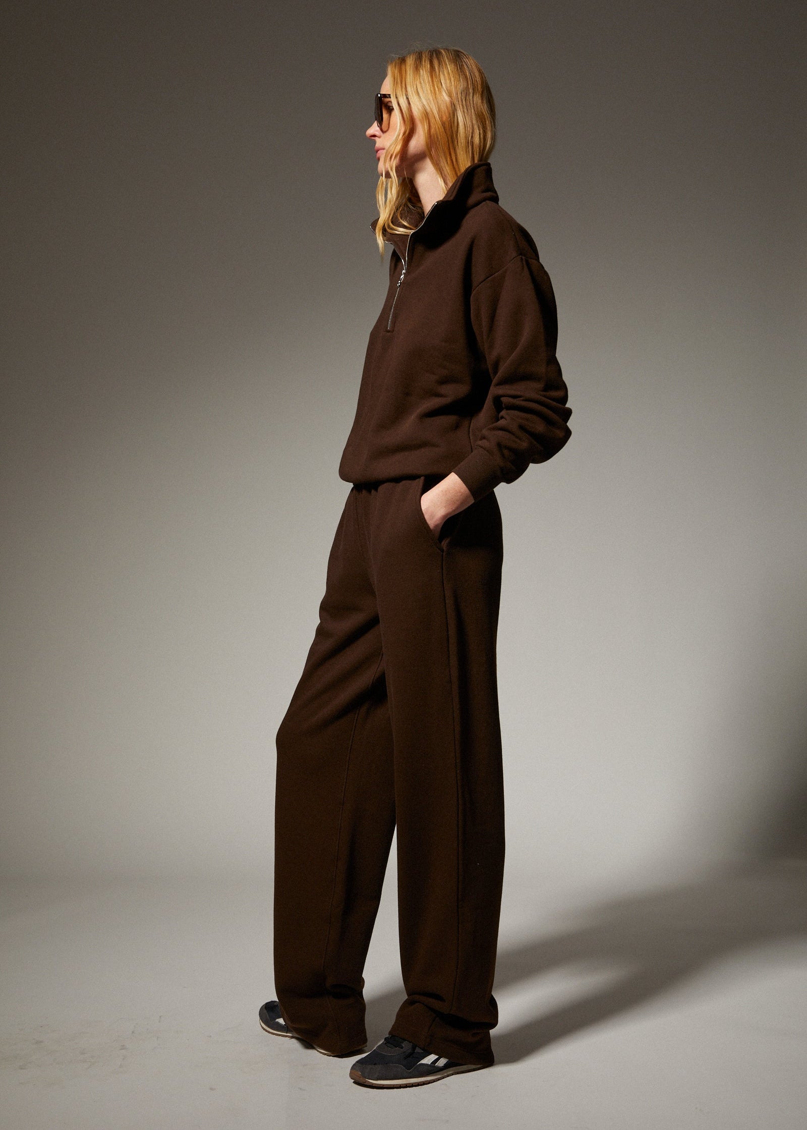 person wearing sprwmn womens Straight Leg Sweatpants quarter zip sweatshirt in Americano