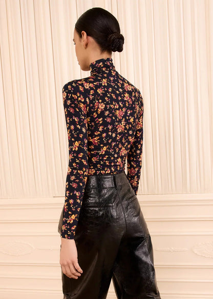 person wearing ulla johnson womens Aurelia Long Sleeve Jersey Top in Noir Floral