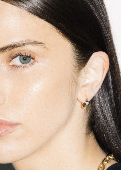 person wearing uniform object fine jewelry 18k yellow gold Power Metal Huggies diamond earrings