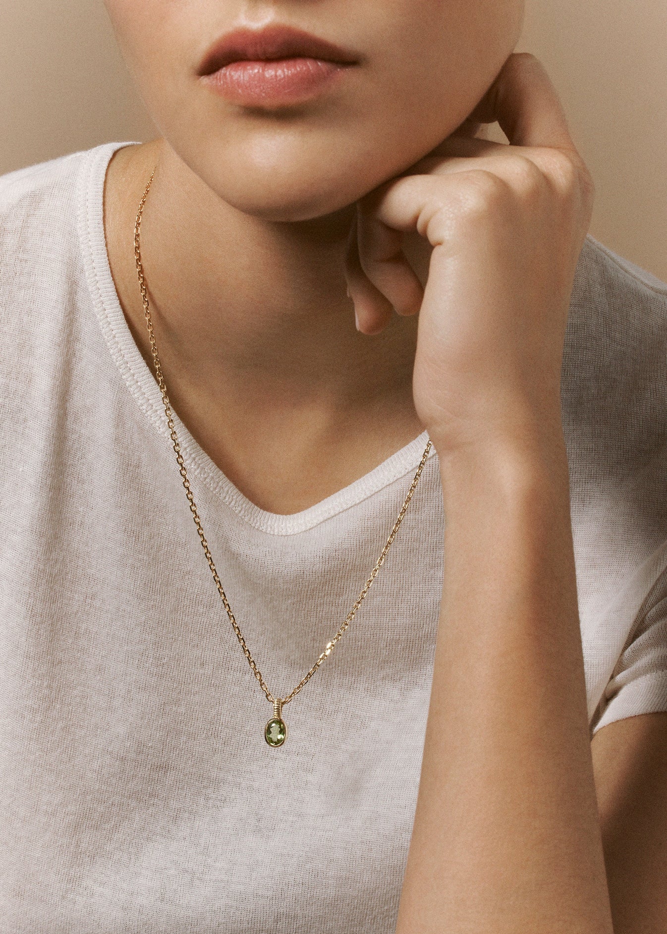 person wearing viltier fine jewelry 18k yellow gold Talisman Charm with Peridot
