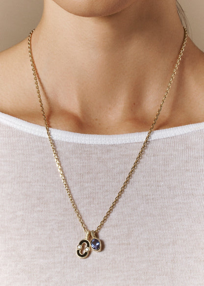 person wearing viltier fine jewelry 18k yellow gold Talisman Charm with Tanzanite magnetic pendant onyx