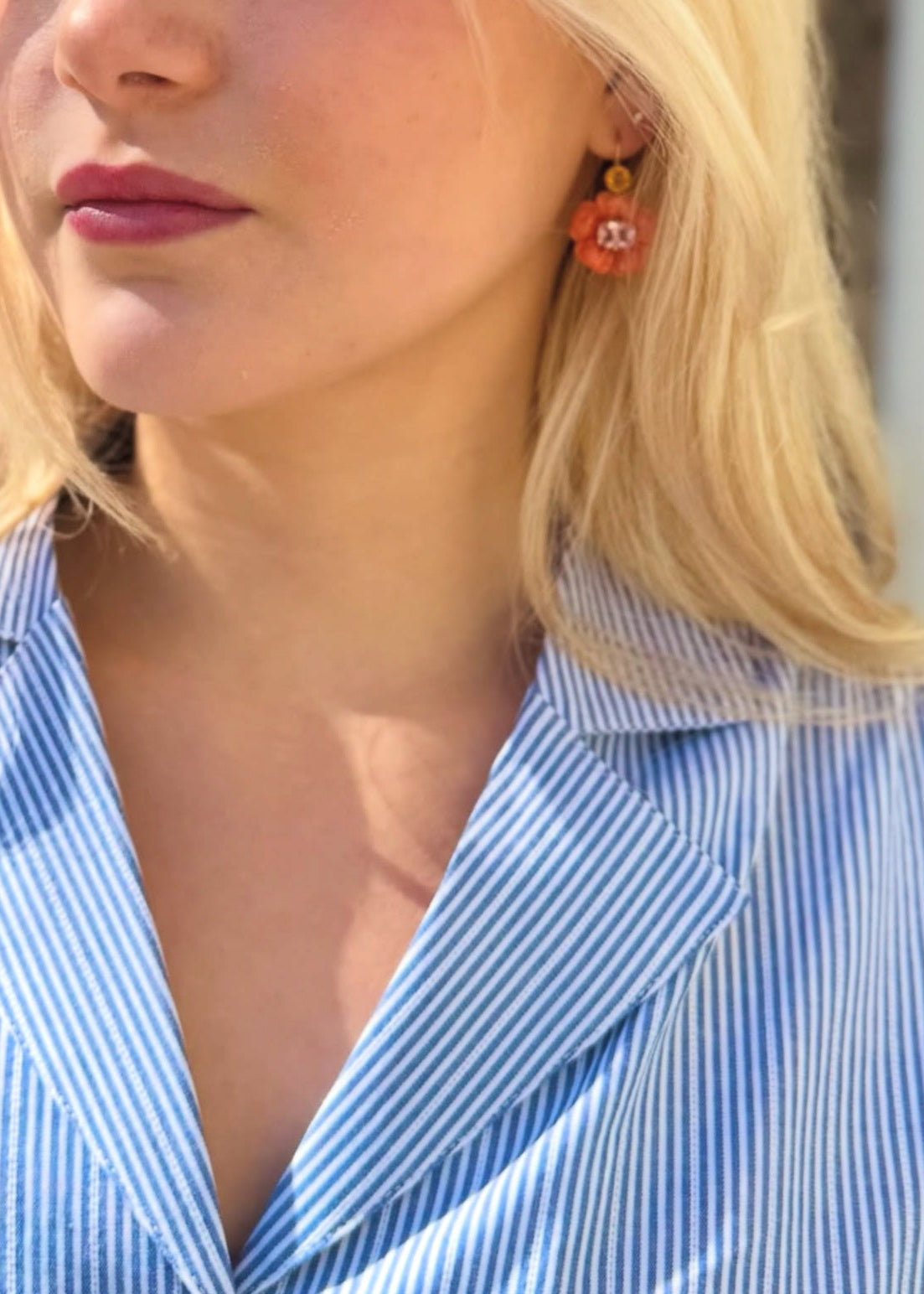 person wearing ciao lucia striped shirt dress and cathy waterman fine jewelry flower earrings