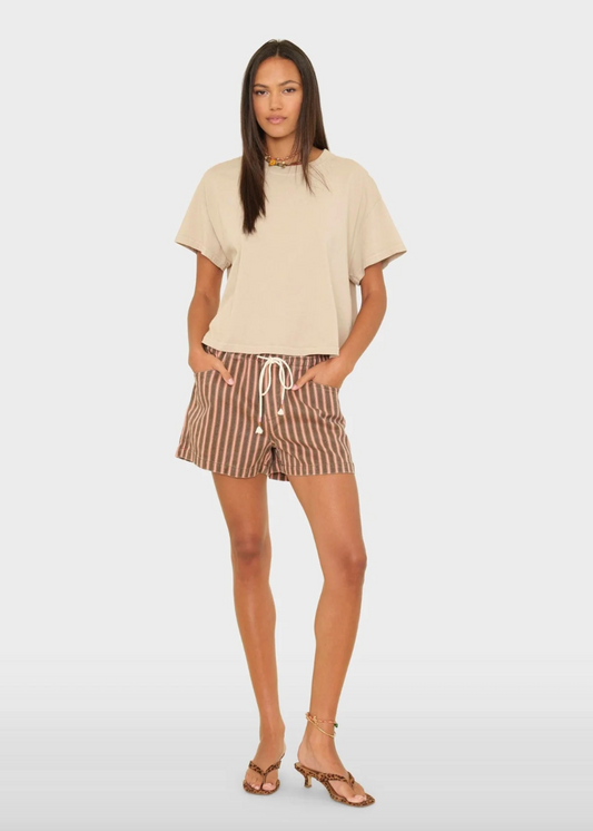 person wearing xirena Tucker Denim Short in Canyon Rose Stripe