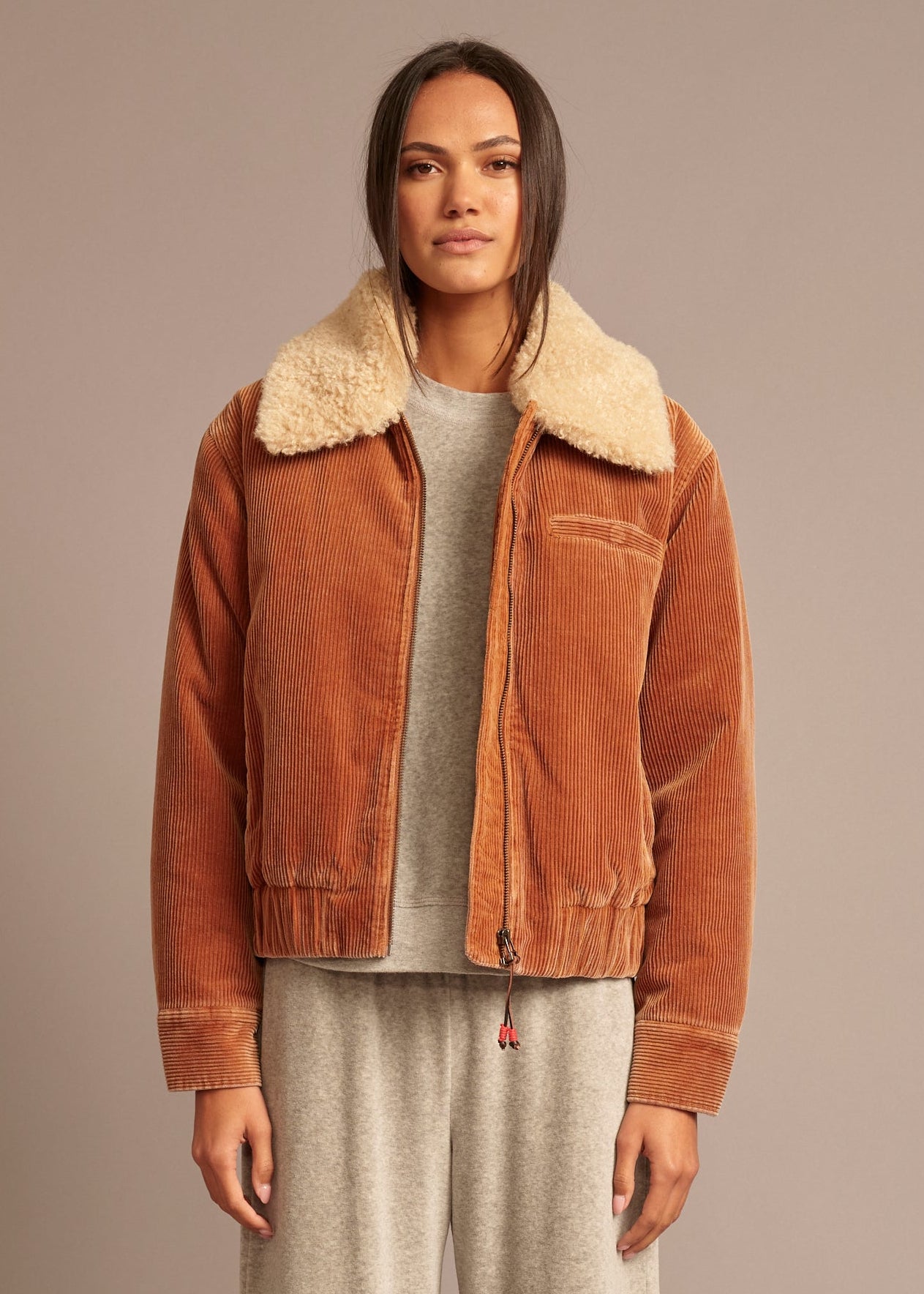 person wearing xirena_womens_corduroy_Bradley_Jacket_in_Camel brown with sherpa collar