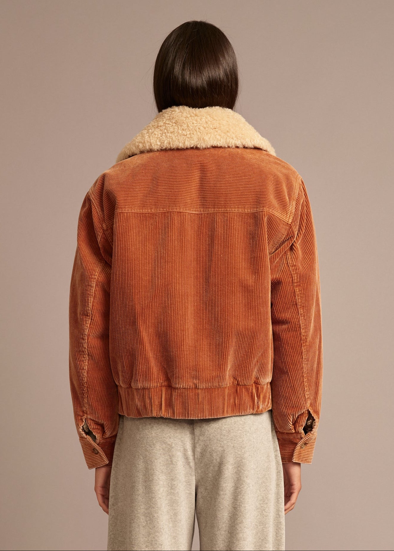 person wearing xirena_womens_corduroy_Bradley_Jacket_in_Camel brown with sherpa collar