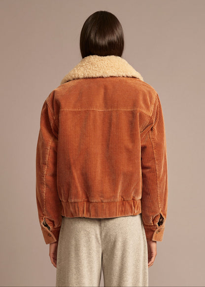 person wearing xirena_womens_corduroy_Bradley_Jacket_in_Camel brown with sherpa collar