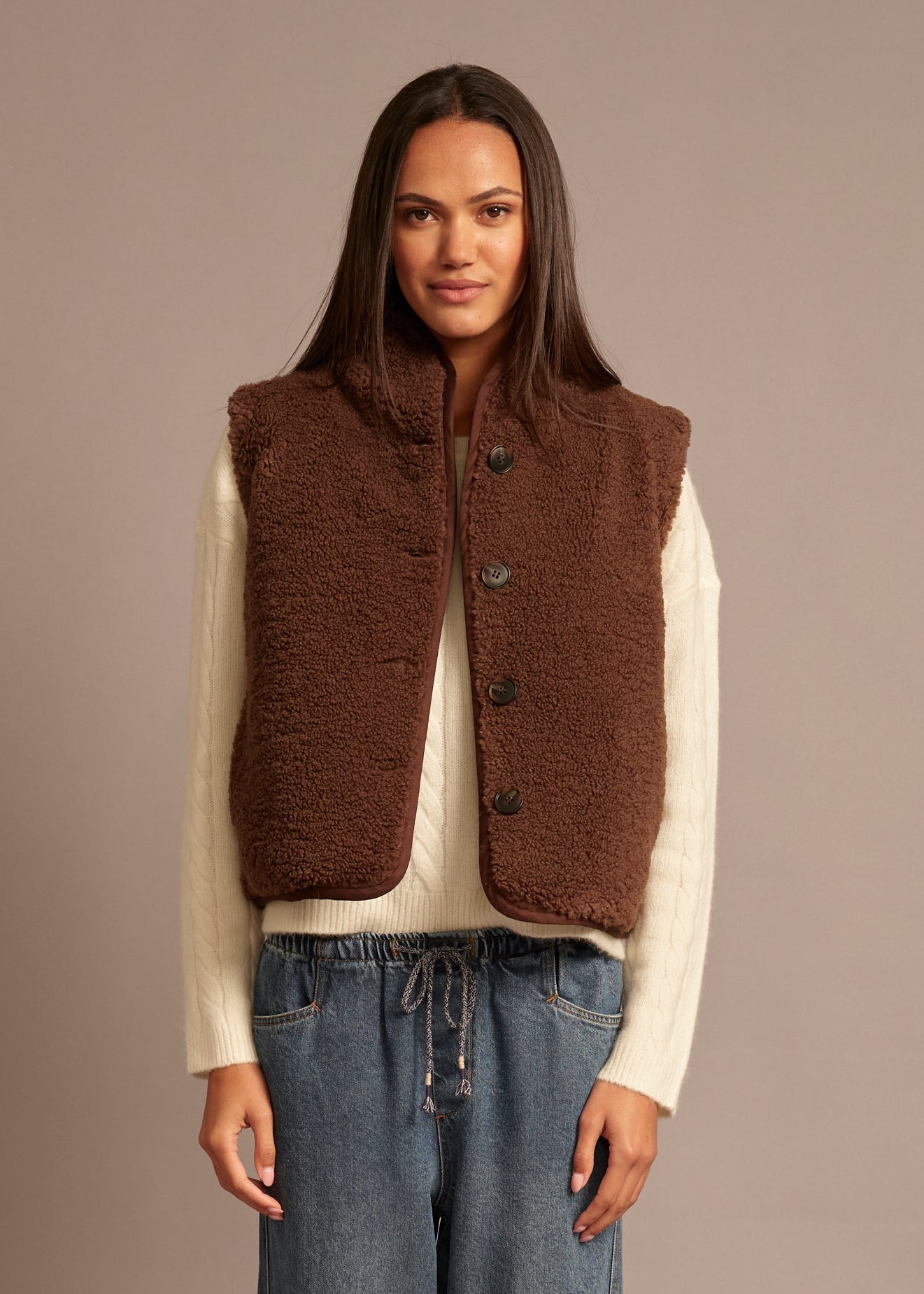 person wearing xirena womens reversible sherpa lined Kensi Vest in chocolate brown
