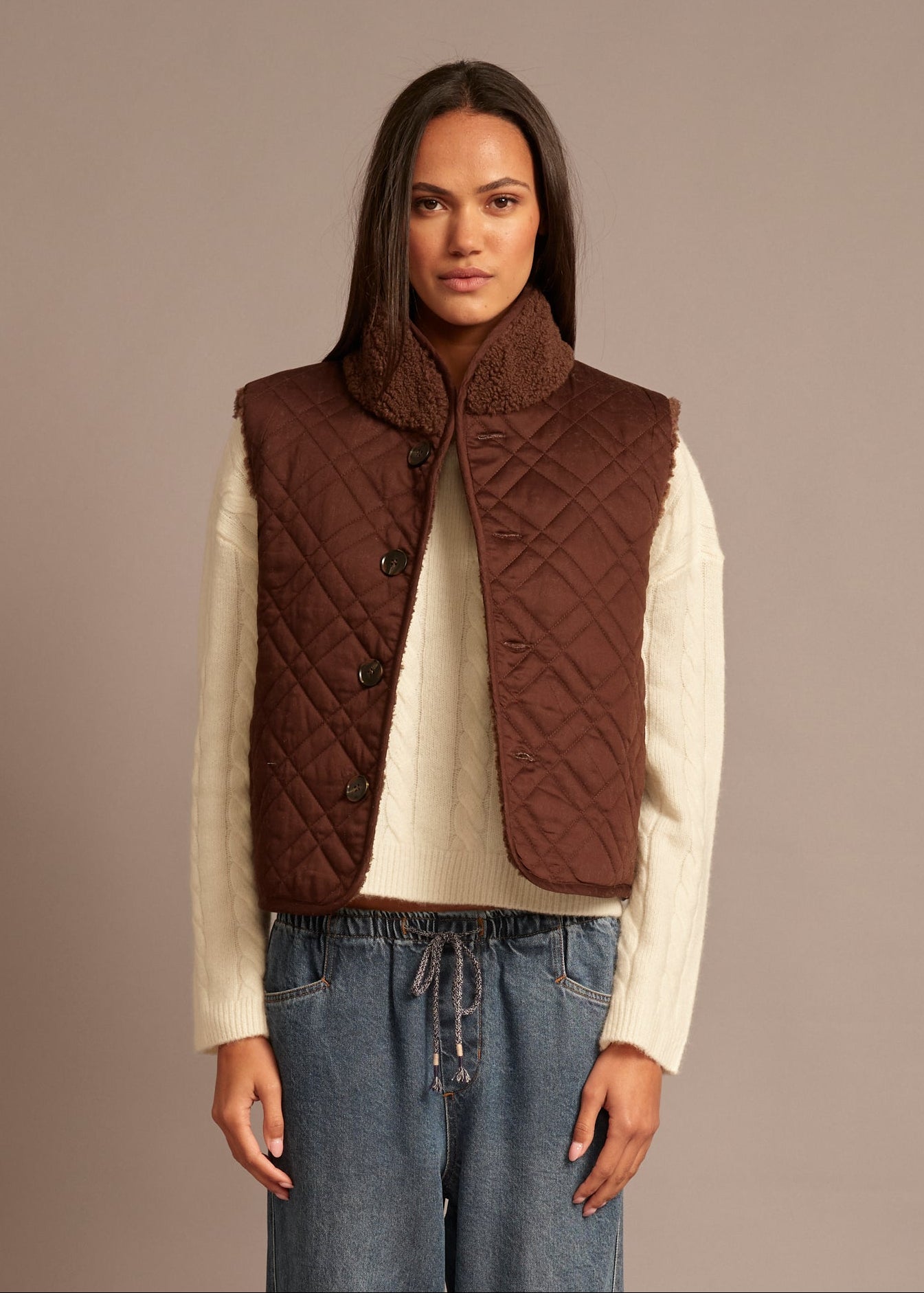 person wearing xirena womens reversible sherpa lined Kensi Vest in chocolate brown