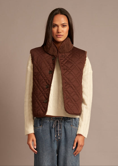 person wearing xirena womens reversible sherpa lined Kensi Vest in chocolate brown