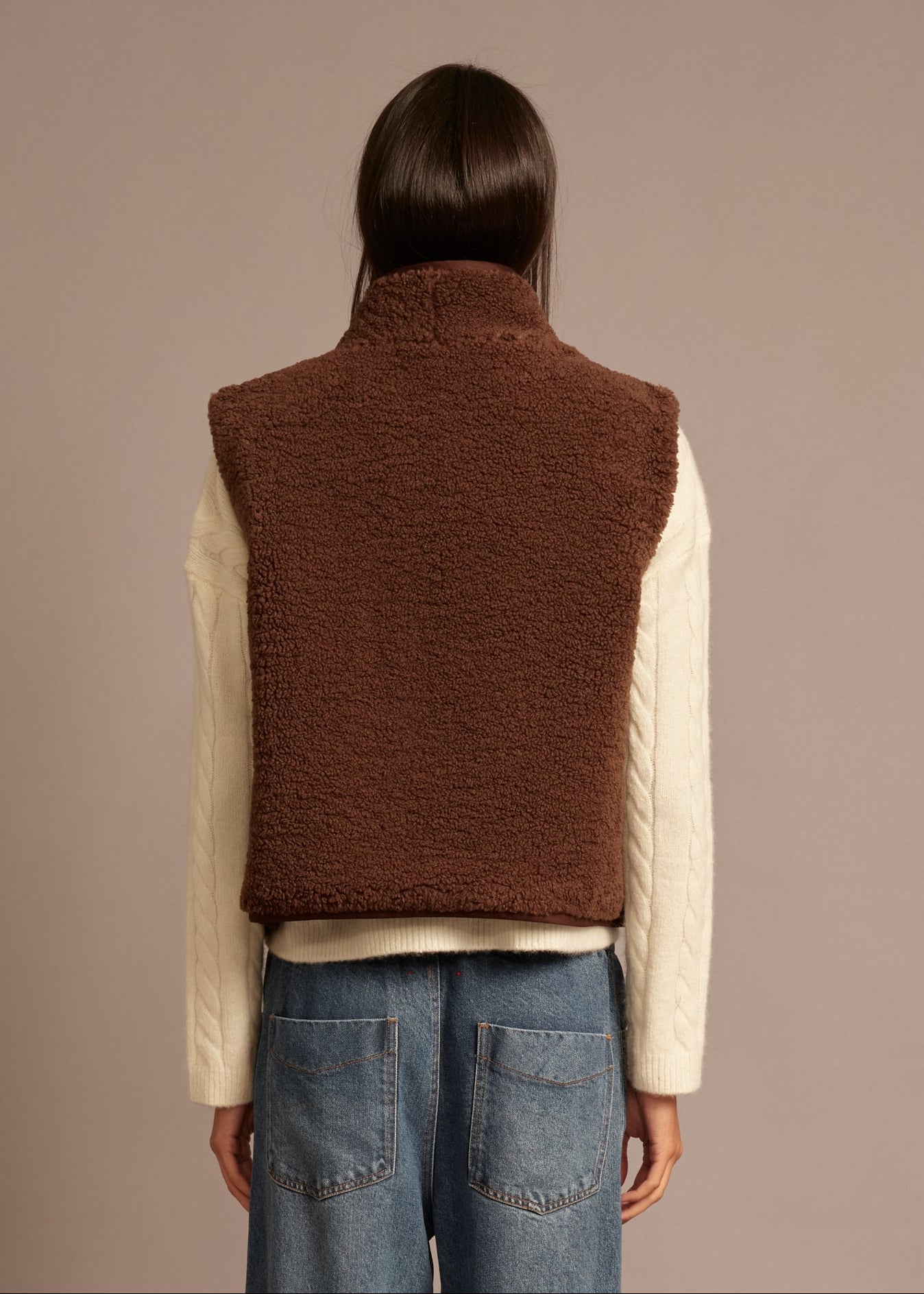person wearing xirena womens reversible sherpa lined Kensi Vest in chocolate brown